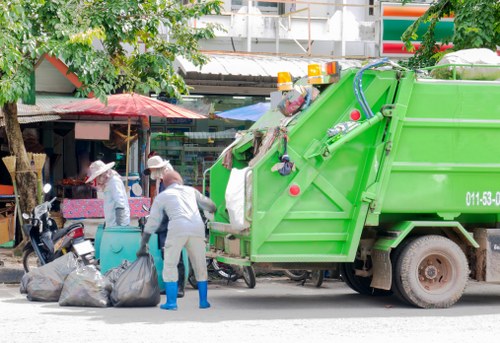 Workers loading waste during a small shop clearance